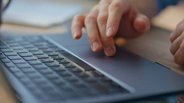 istock Closeup person typing laptop in sunlight. Man hands using touchpad in office. 2170476372