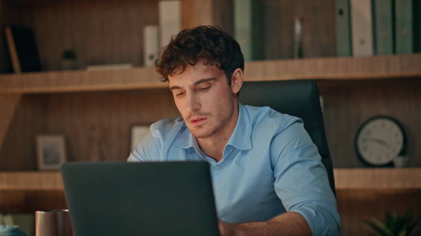 istock Fatigued employee watching computer screen having overtime work office close up. 2170476714