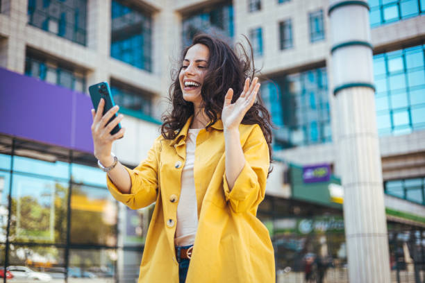 istock Cheerful Woman Having Video Call in Urban Setting 2170478476