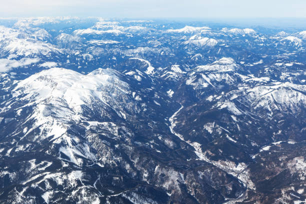 Aerial view of a majestic snowy mountain range. Alps  mountains are covered in snow, view from above