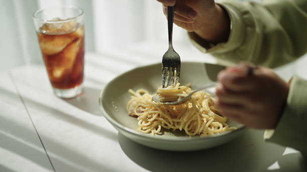 Spaghetti carbonara on fork,isolated on white with clipping path.