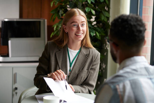 istock housing officer assisting a tenant with forms 2170482333
