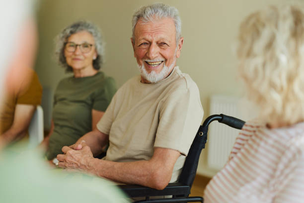 istock Disabled senior man talking to his friends in nursing home. 2170484101