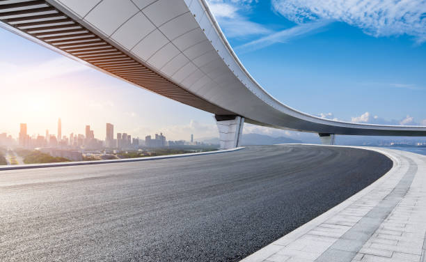 istock Asphalt road and bridge with modern city skyline background 2170485148