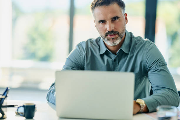 istock Serious businessman working on laptop in the office. 2170485420