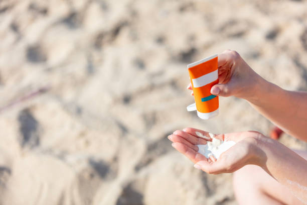 istock Close-up of woman's hand squirting sunscreen lotion 2170485495