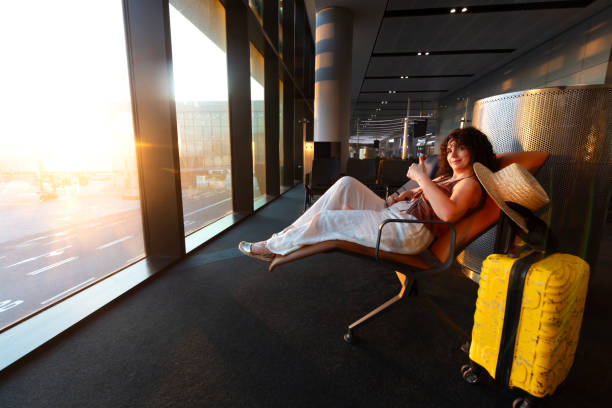 istock Girl  is sitting while waiting at the airport 2170486801