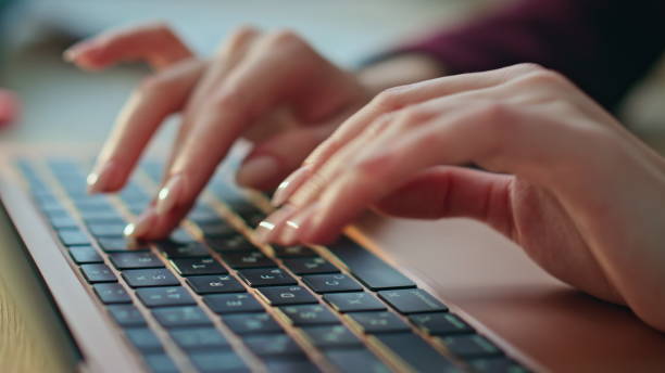 istock Closeup freelancer typing laptop at desk. Woman hands browsing internet online 2170491422