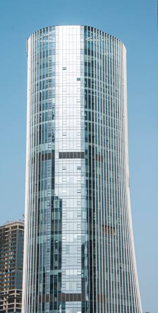 istock Modern curved high-rise office building against blue sky. 2170491439