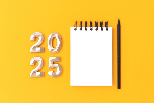 istock Empty notepad mockup, pencil and golden 2025 numbers on a yellow background. 2170492387