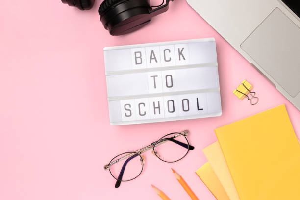 istock Back to school. Workspace with lightbox, eyeglasses, laptop and office supplies on a pink background. 2170493608