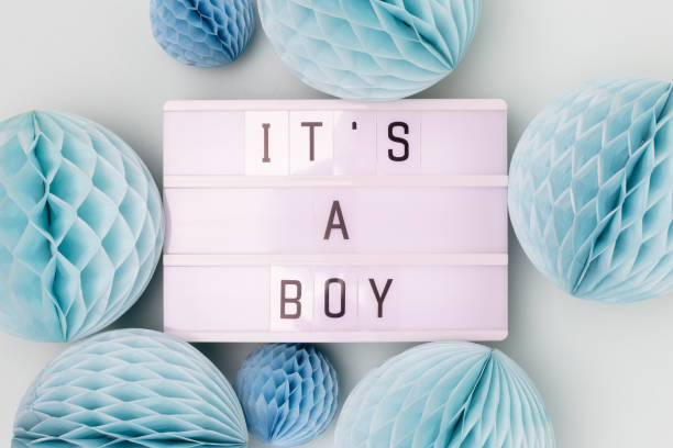 istock It's a boy. Lightbox with letters and tissue paper balls in a blue color. 2170493791