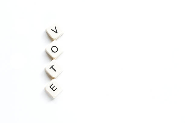 Voting, important decision making. Four white tiles arranged vertically to spell the word VOTE against a clean white background. Each tile features a bold black letter.