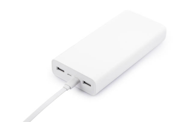 istock Powerbank for charging mobile devices with cable on white table 2170494472