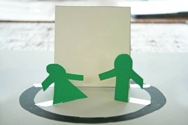 Cutout figures of people joyfully holding hands, ideal for familythemed designs and festive decorations