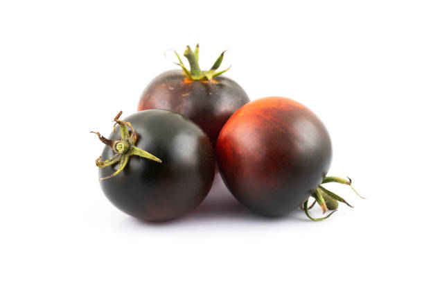 fresh black tomatoes isolated on a white background, macro tomato.