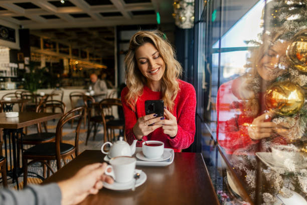 A couple drinking tea in a cafe during Christmas holidays