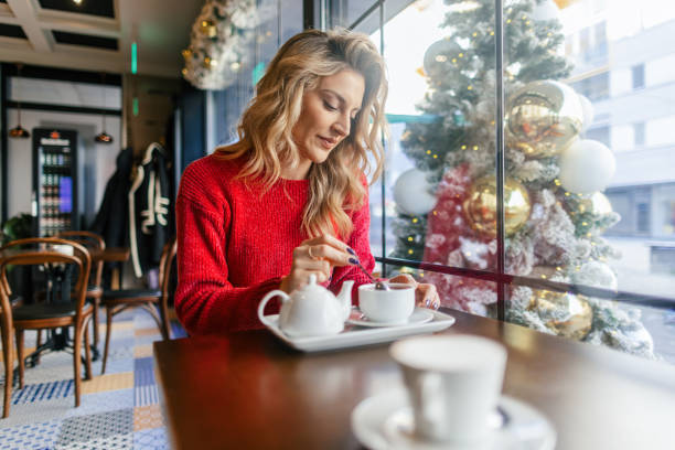 istock Woman drinking tea in a cafe during Christmas holidays 2170496526