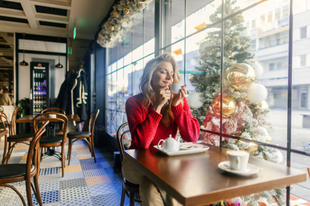 istock Woman drinking tea in a cafe during Christmas holidays 2170496528