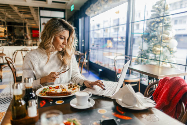 Woman having breakfast in a cafe during Christmas holidays