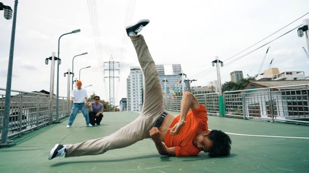 istock Young happy hipster perform break dancing or foot step with friend. Sprightly. 2170496621