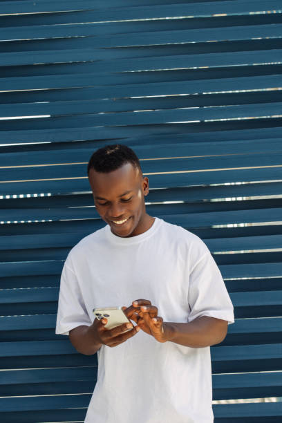istock Ecstatic young man using trendy smartphone, smiling joyfully, millennial guy enjoy new mobile application 2170497296