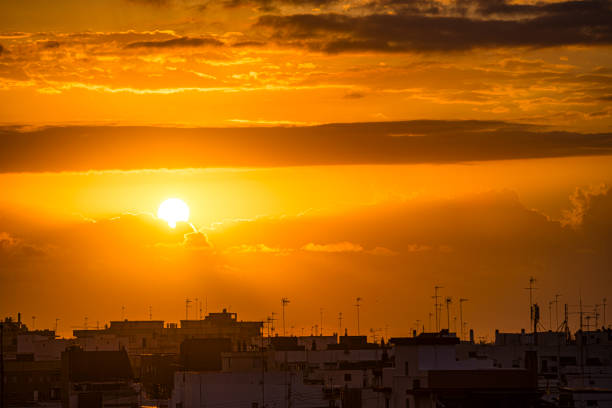 Dramatic yellow sunrise or sunset over the city