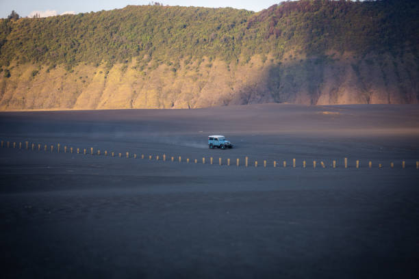 Off road vehicle on the volcanic caldera at Mount Bromo, East Java Indonesia.