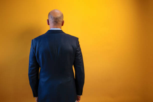 Studio portrait of a middle eastern middle-aged bearded businessman posing against a dark background