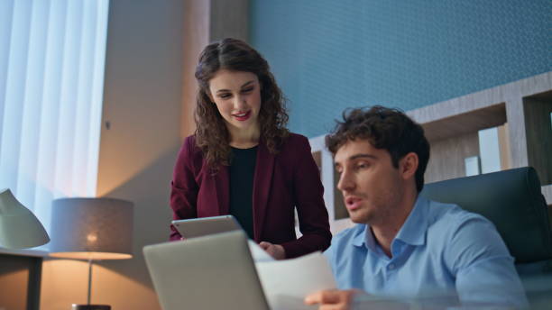 istock Two coworkers examining papers working together in company office close up. 2170498152