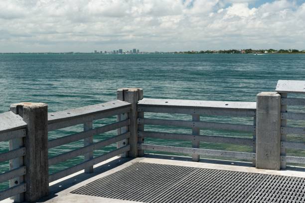 istock Concrete pier with ocean view and distant city skyline. 2170498178