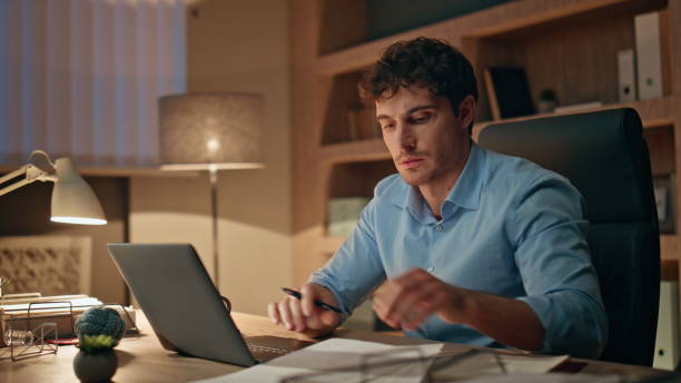 istock Late worker typing laptop busy of overtime work close up. Man holding documents 2170498650