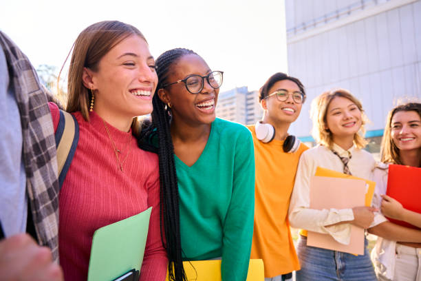 istock Side view cheerful student group multiracial classmates people standing hugging together for photo. 2170499216