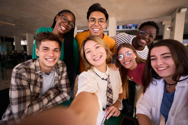 istock Selfie group of happy young multiracial university students looking smiling at camera in study room. 2170499389