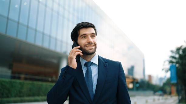 istock Manager calling phone while walking at city with blurred background. Exultant. 2170500961