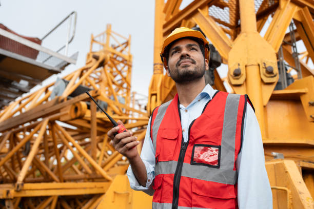 istock India Asia engineer man worker use walkie talkie with spare crane background 2170501350