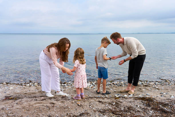 Family with two children enjoying life on the beach a summer day