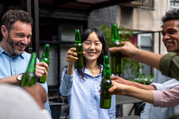 Mid-shot front view of female millennial human resources advisor hosting informal client appreciation gathering event at company's terrace