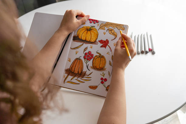 istock Hand drawing colorful autumn-themed illustrations in sketchbook 2170506341