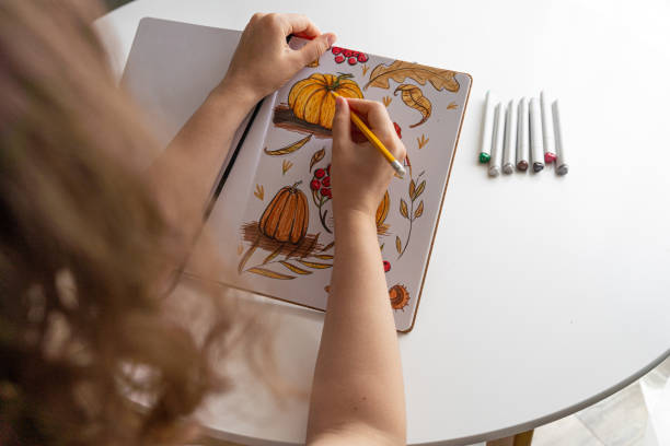 istock Hand drawing colorful autumn-themed illustrations in sketchbook 2170506342