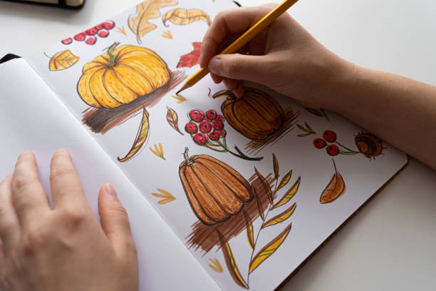 istock Hand holding marker while drawing autumn illustration 2170506390