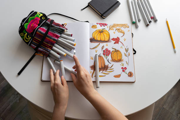 istock Hand drawing colorful autumn-themed illustrations in sketchbook 2170506538