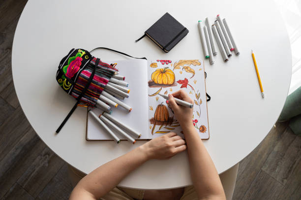 istock Hand drawing colorful autumn-themed illustrations in sketchbook 2170506541