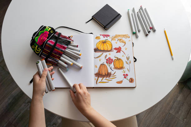 istock Hand drawing colorful autumn-themed illustrations in sketchbook 2170506545