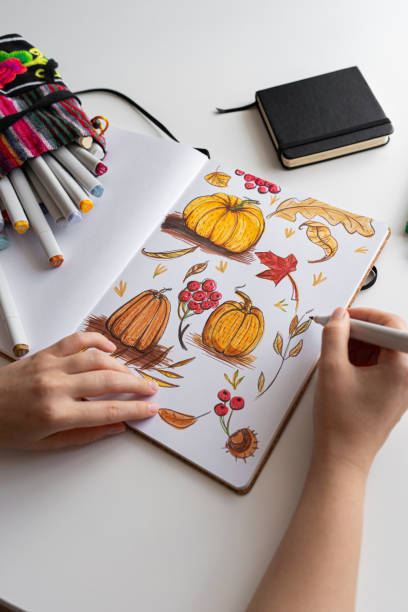 istock Hand drawing colorful autumn-themed illustrations in sketchbookv 2170506592