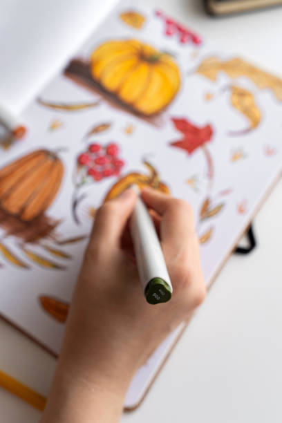 istock Hand holding marker while drawing autumn illustration 2170506605