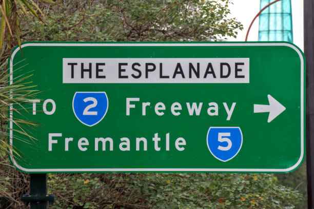 A clear shot of directional road signs for the Trans-Canada Highway (Highway 1) East and West, along with Manitoba Provincial Road 250. Captured during a cross-country road trip across the Canadian Prairies. The image features the iconic maple leaf shields under a bright summer sky, symbolizing Canadian travel, logistics, and the vast highway network.