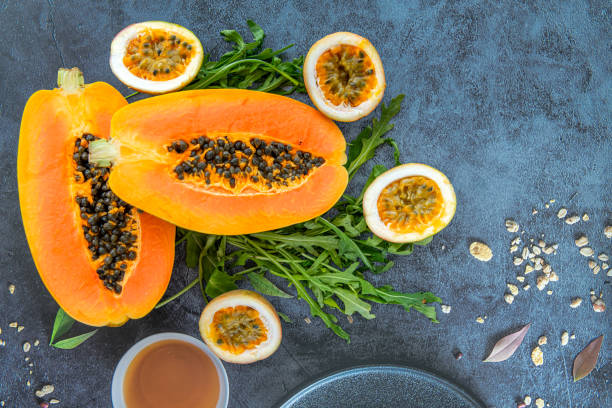 istock Papaya, passion fruit and rucola on a blue stone kitchen table background 2170510800