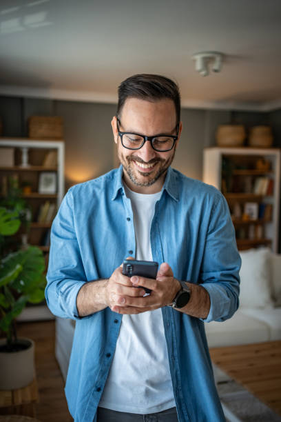 istock Portrait of cheerful man using smartphone to read messages or scroll through social networks, daily routine 2170511018