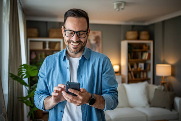 istock Portrait of cheerful man using smartphone to read messages or scroll through social networks, daily routine 2170511020